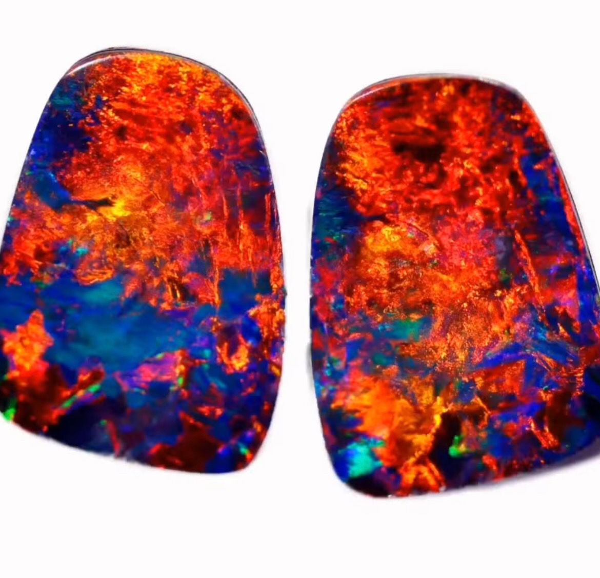 Close view of vibrant red and blue opal doublet pair showing strong play of color featured in the opal doublet guide
