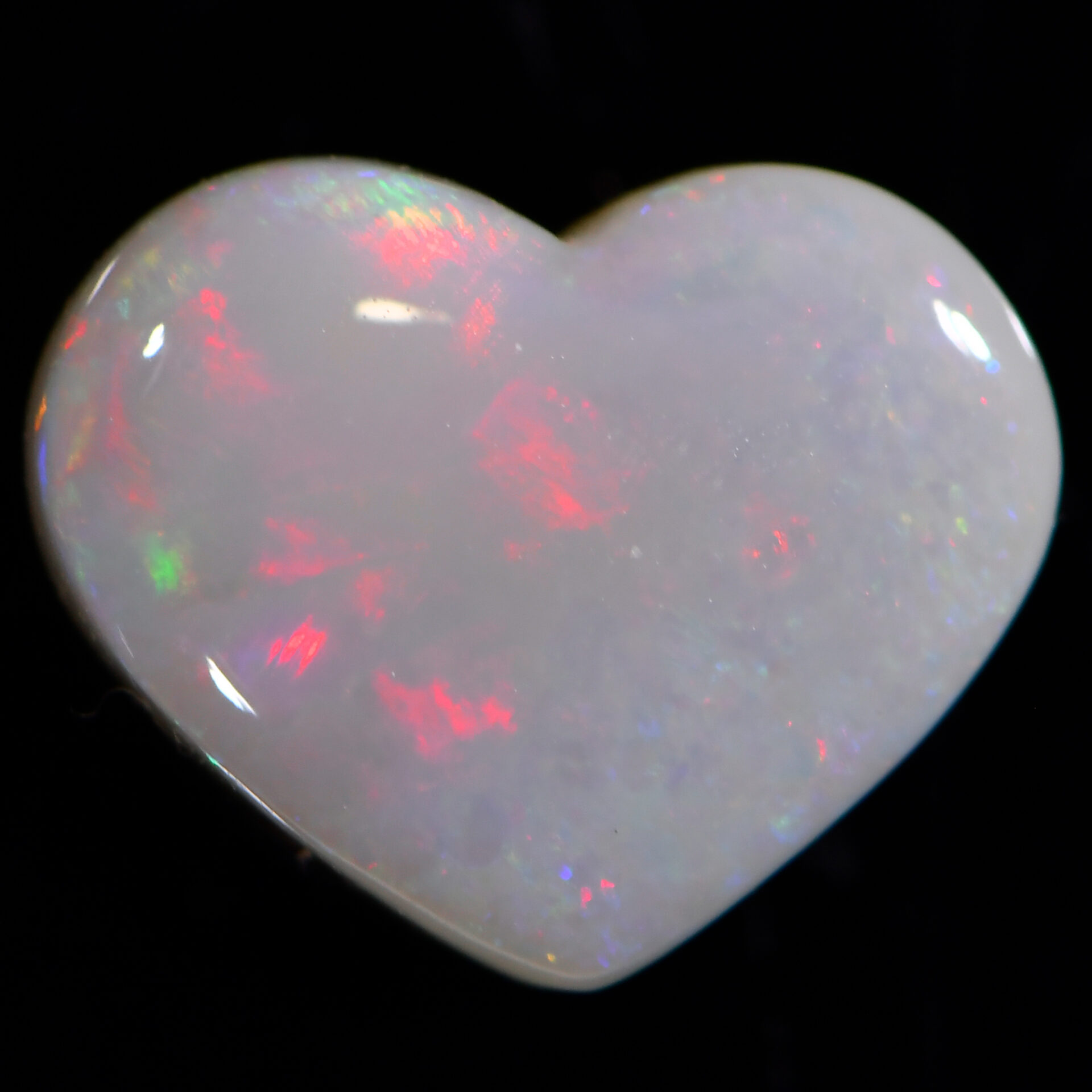 2.2ct natural dark opal heart shape with soft pink flash from Lightning Ridge, Australia – ideal for rings.