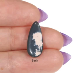 Back view of a 2.84ct solid black opal teardrop cabochon resting in a palm, showing the dark grey potch base, Lightning Ridge Australia