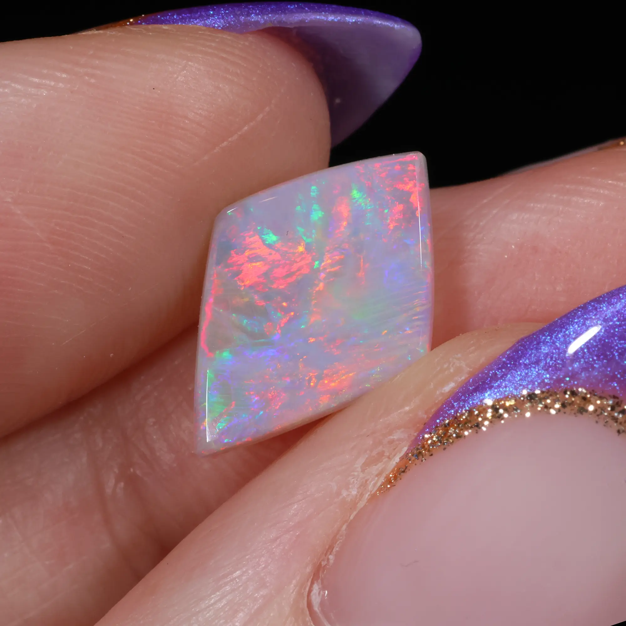 Light Opal 13.5x9.2x2.8mm – 1.61ct Rainbow Fire Gemstone - hand shot