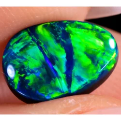 Natural black opal teardrop showing vivid green and blue fire with galaxy pattern play of color on dark body tone for Opal Galaxy product video thumbnail