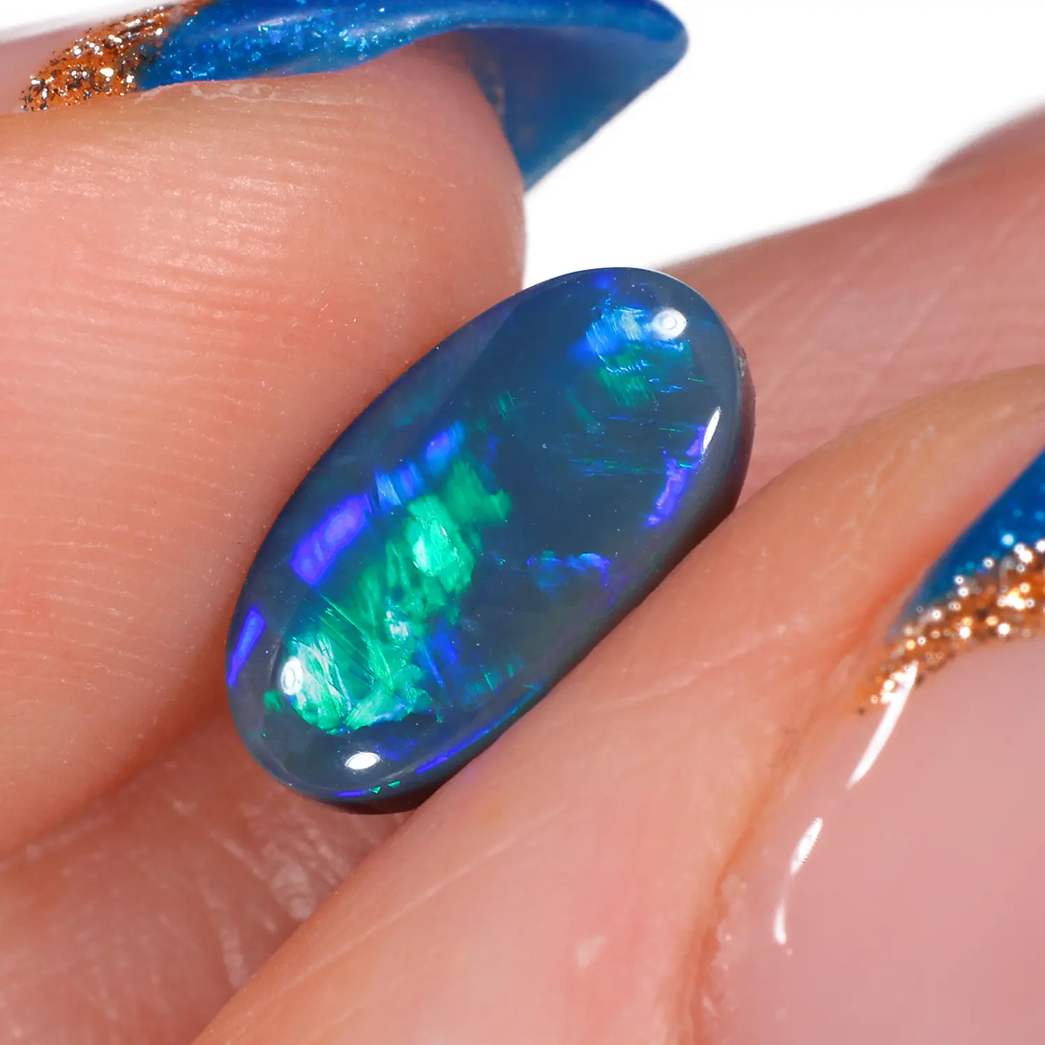1.51ct Natural Black Opal Oval Cut Green Blue Fire-hand shot