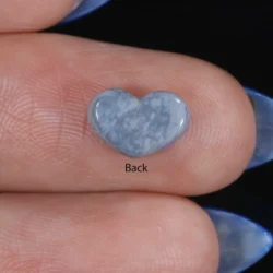 Back view of a 1.19ct natural dark opal heart cabochon resting on fingers, showing a pale grey-blue potch base, Lightning Ridge Australia