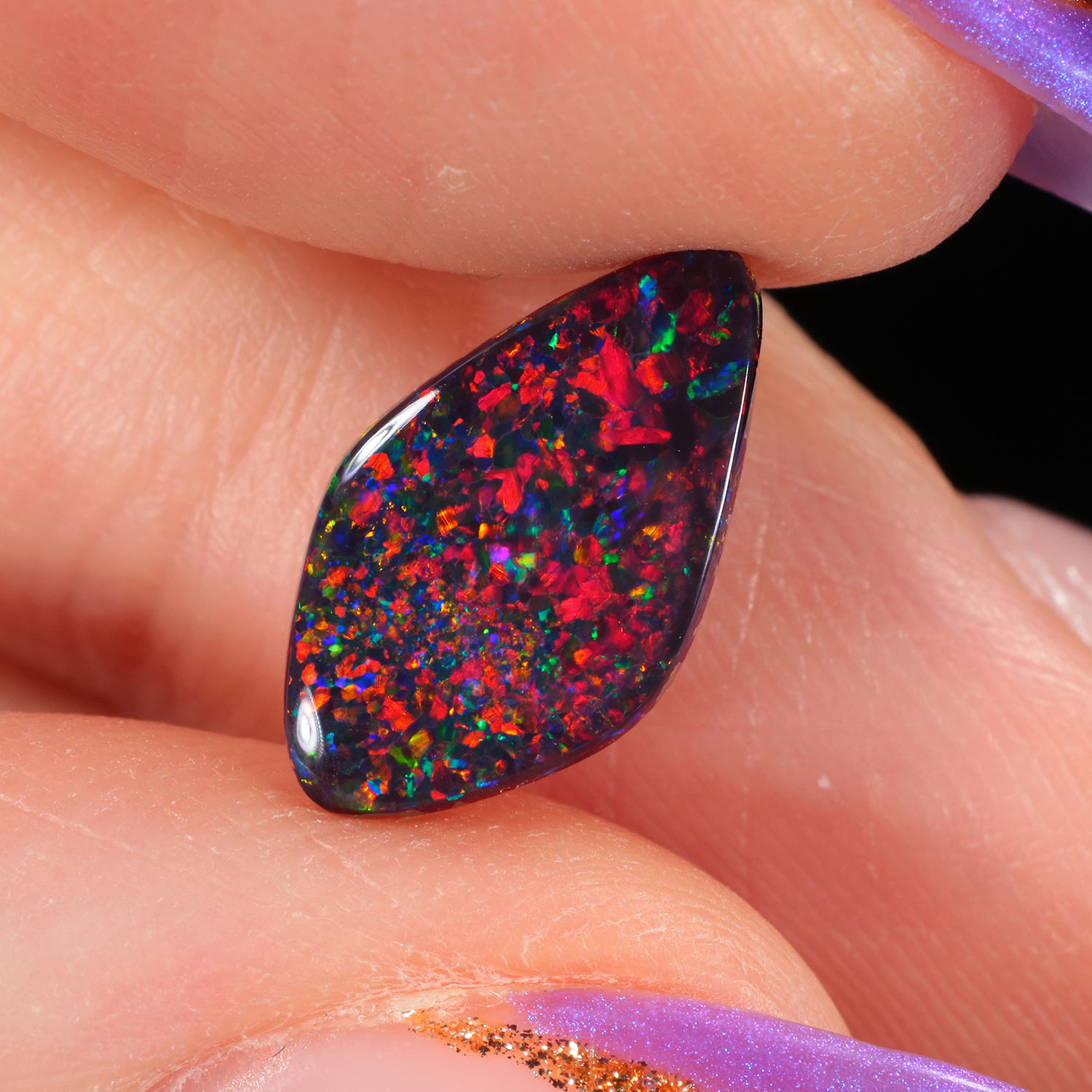 1.68ct Natural Black Opal - Marquise Sparkling Cherry Red - hand shot