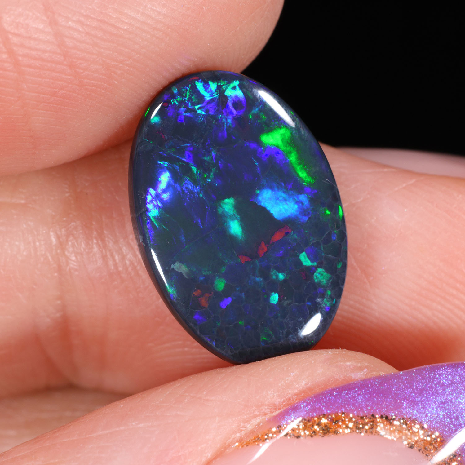 3.54ct Natural Black Opal - Oval Blue Green Red Fire - hand shot1
