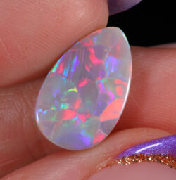 3.64ct Natural Dark Opal -Teardrop Rainbow Fire - hand shot