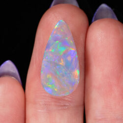4.05ct Natural Dark Opal -Teardrop Rainbow Fire - hand shot