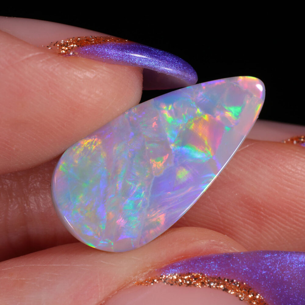 4.05ct Natural Dark Opal -Teardrop Rainbow Fire - hand shot1