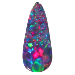 2.64ct black opal on white background showing vivid red, green, and violet fire