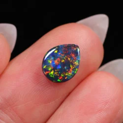 opal on finger for scale