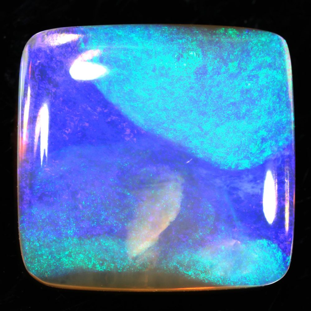 Crystal boulder opal 14 ct square close view showing bright blue green and purple color with a smooth polish.