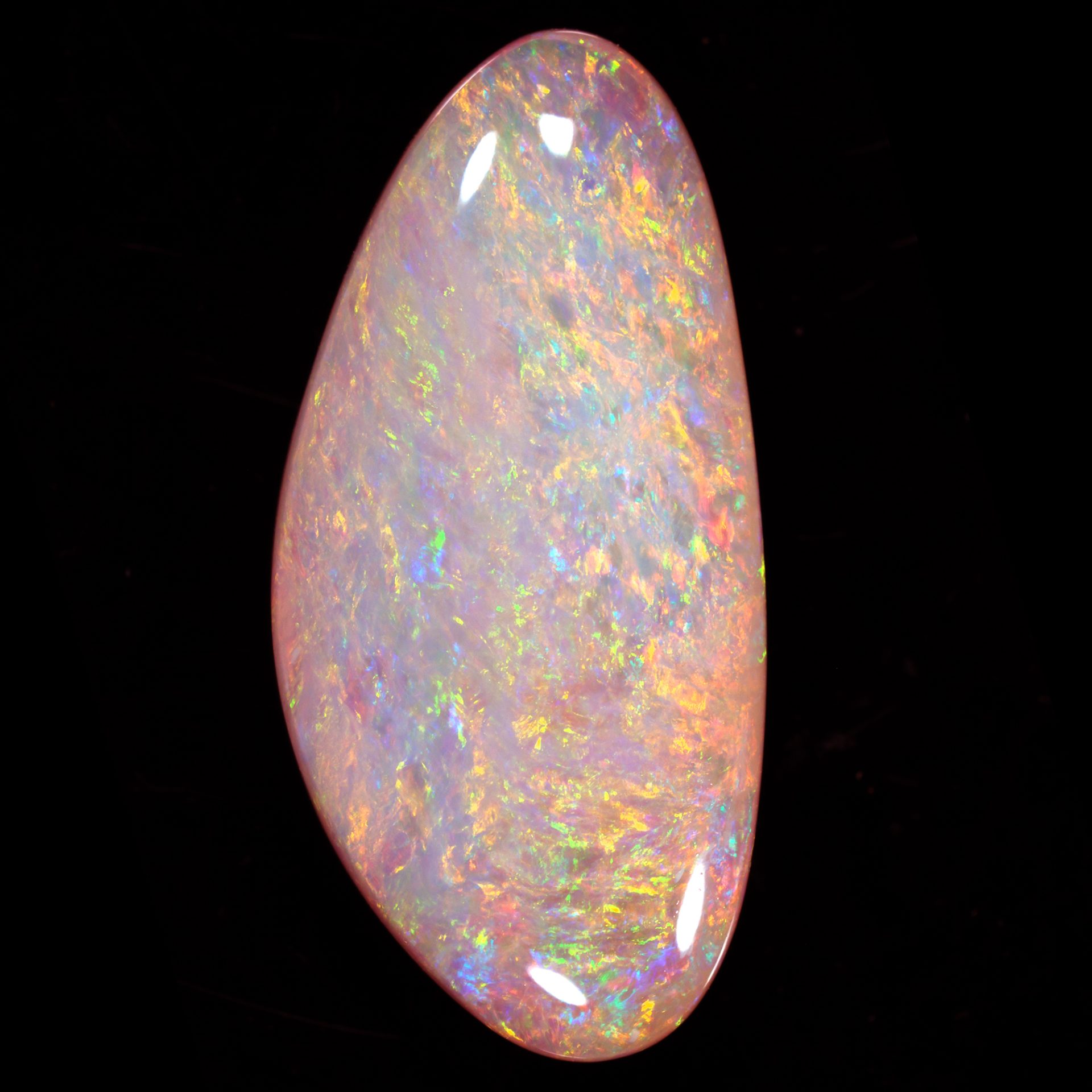 Natural crystal boulder opal 20.4 ct pipe opal on a black background showing close view of bright rainbow fire.