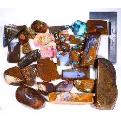 Mixed bag Queensland boulder opal rubs rough parcel showing fossil opals and matrix patterns