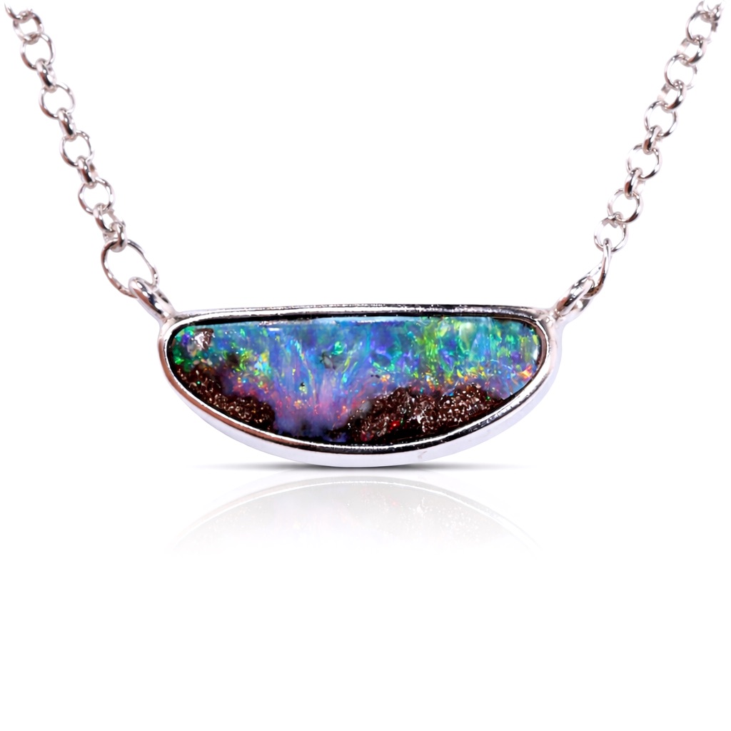 Natural 24.5ct rainbow boulder opal pendant in sterling silver showing vivid multicolor fire with green blue red and yellow flashes