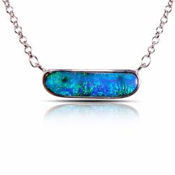 29.7ct Australian boulder opal pendant horizontal style with deep blue green ocean fire set in sterling silver shown on white background with reflection.