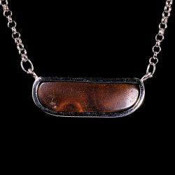 Back view of 29.7ct Australian boulder opal pendant showing natural ironstone host rock in a refined silver bezel setting.