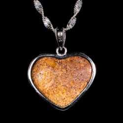 Back view of natural Australian boulder opal heart pendant showing ironstone backing sterling silver setting.