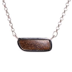 Back view of royal blue boulder opal pendant 24.5ct showing natural ironstone backing and silver bezel.