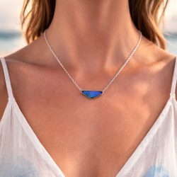Boulder opal pendant in purplish blue triangular shape worn on 18 inch silver chain, natural untreated Australian opal 25.6ct.