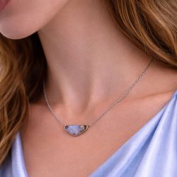 Triangular boulder opal pendant with soft pink rainbow tones worn on adjustable silver chain natural untreated Australian opal 23.3ct.
