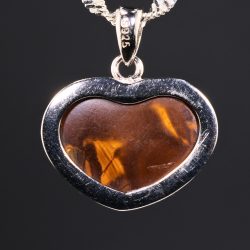 Rear view of purple boulder opal pendant showing natural ironstone backing
