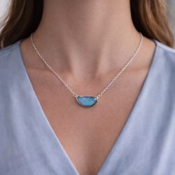 Australian boulder opal necklace from Winton worn on model displaying ocean blue and green colorplay in a horizontal sterling silver setting.