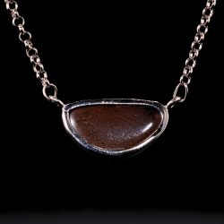Back of 24.7ct Australian boulder opal pendant from Winton showing natural ironstone host rock in a sterling silver horizontal setting.