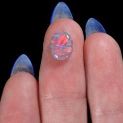 Lightning Ridge dark opal oval cabochon with strong red fire and green blue flashes.