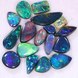 13.35ct Gem black opal jewelers parcel of 17 polished cabochons from Lightning Ridge, Australia with green, blue, purple, and red fire. Natural, untreated solid black opals.