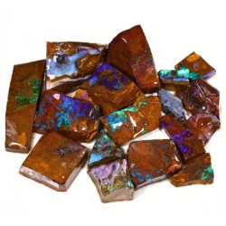 188g boulder opal rubs rough parcel of 17 pieces from Winton, Australia with blue, purple, teal, and green fire through warm reddish brown ironstone matrix. Natural, untreated.