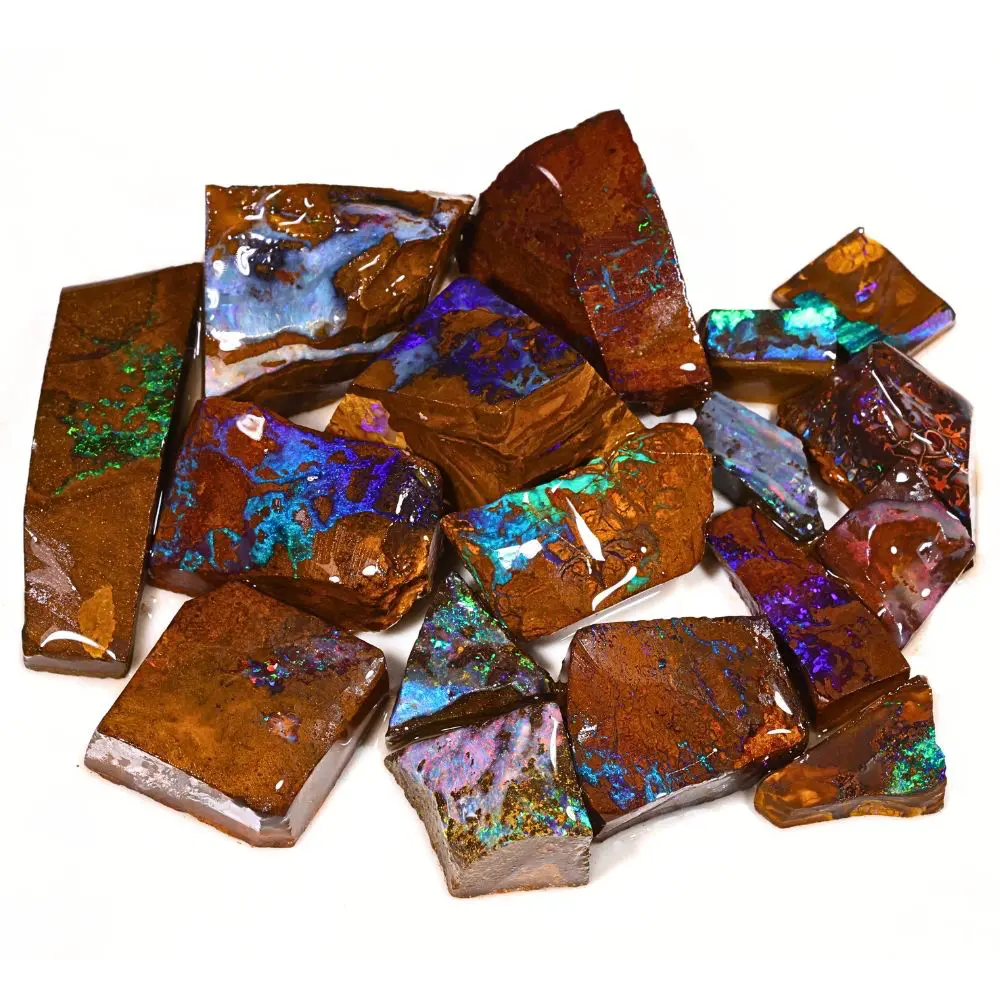 188g boulder opal rubs rough parcel of 17 pieces from Winton, Australia with blue, purple, teal, and green fire through warm reddish brown ironstone matrix. Natural, untreated.