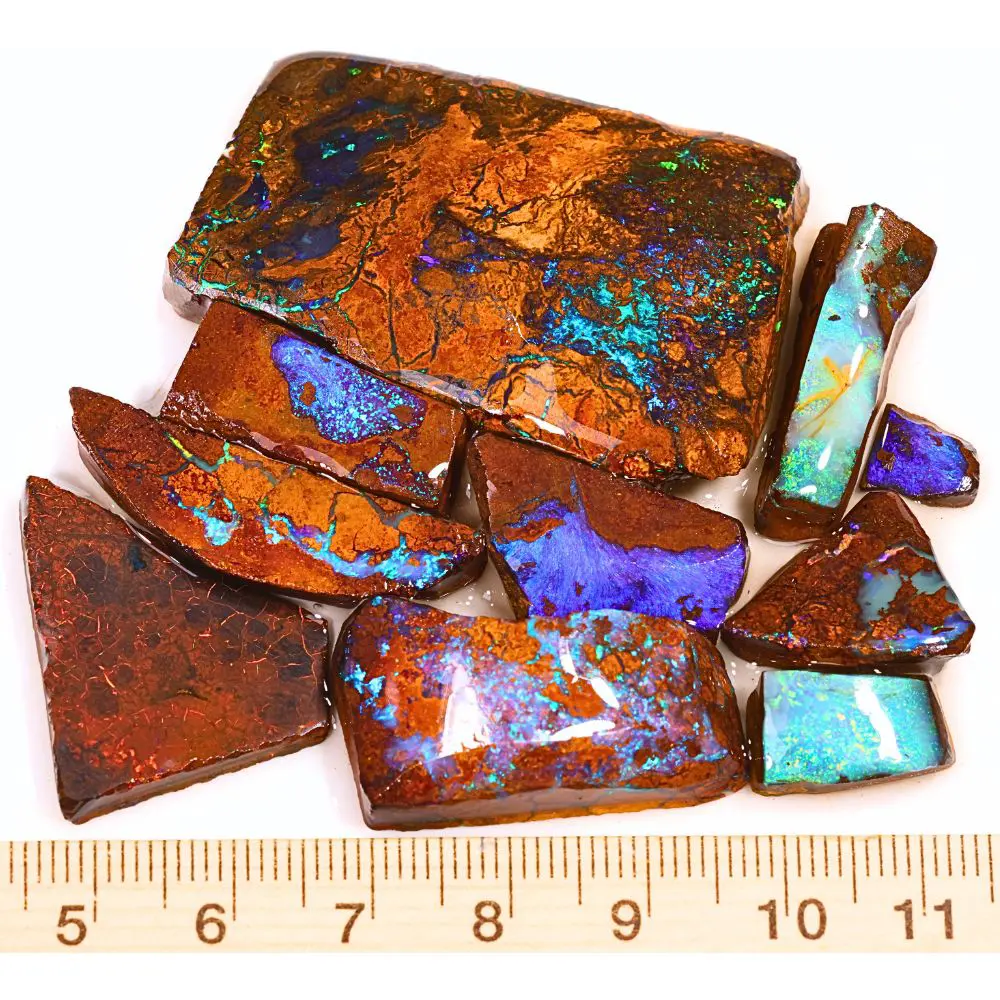 299ct boulder opal rubs parcel from Queensland, Australia showing blue, purple, and green color play through natural ironstone matrix. 100% natural and untreated.