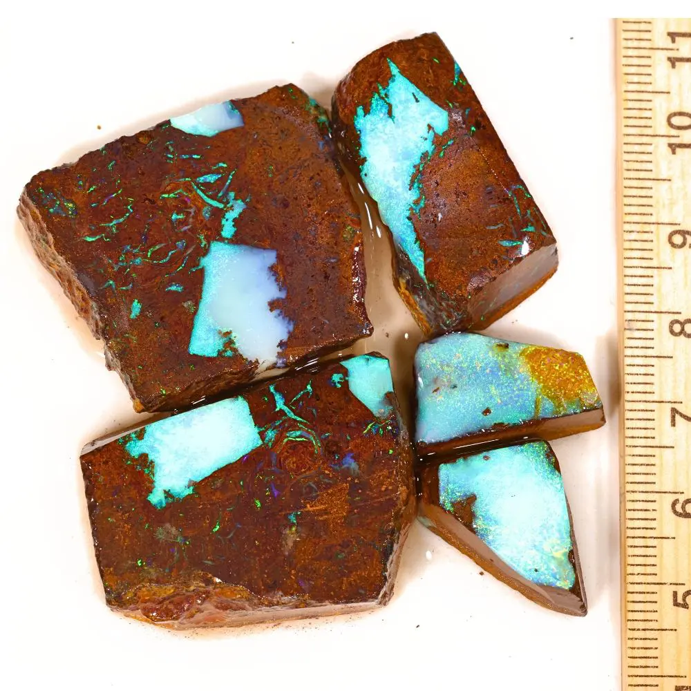 328ct Koroit boulder opal rubs parcel from Queensland, Australia showing vivid sky blue opal pockets and green veining through natural ironstone matrix. 100% natural and untreated.