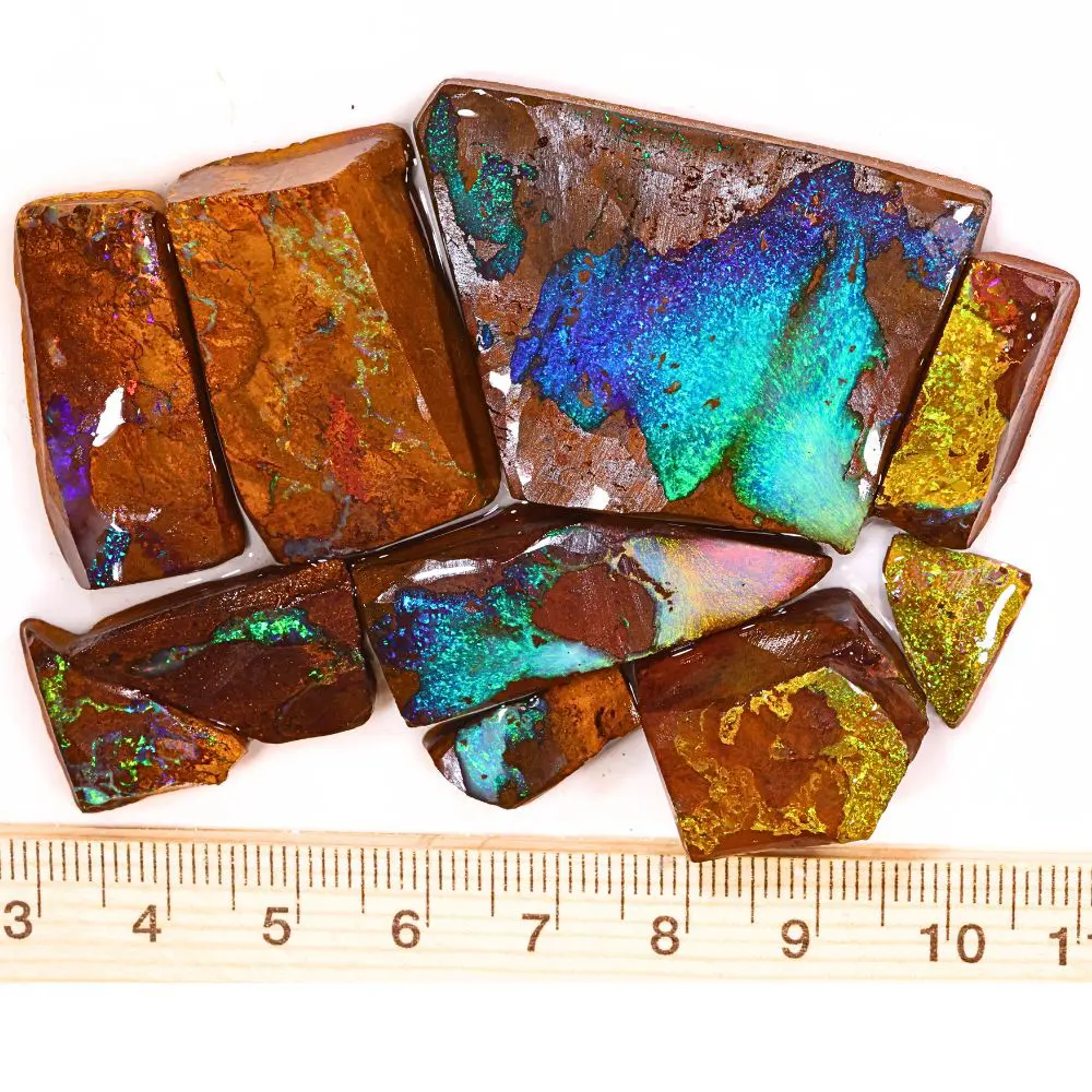 374ct boulder opal rubs parcel from Queensland, Australia showing vivid blue, teal, and gold color play through natural ironstone matrix. 100% natural and untreated.