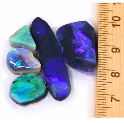 38ct Lightning Ridge black opal rubs parcel from Australia showing deep blue and purple fire on larger pieces with vivid green and teal fire on smaller stones. 100% natural and untreated.