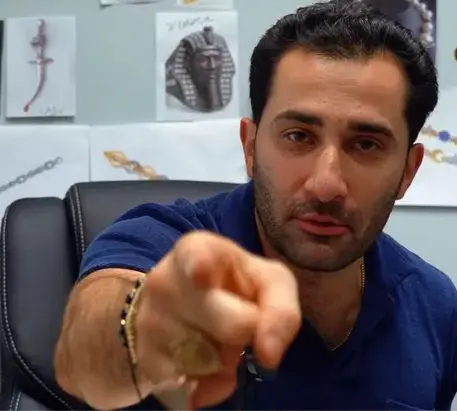 TraxNYC founder Maksud Agadjani presenting an opal in New York City's Diamond District