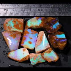 200ct crystal boulder opal rubs parcel from Winton, Australia showing translucent pastel opal with green, pink, and blue fire across broad polished faces. 100% natural and untreated.