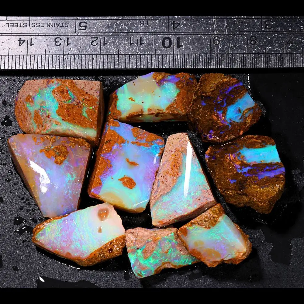 200ct crystal boulder opal rubs parcel from Winton, Australia showing translucent pastel opal with green, pink, and blue fire across broad polished faces. 100% natural and untreated.