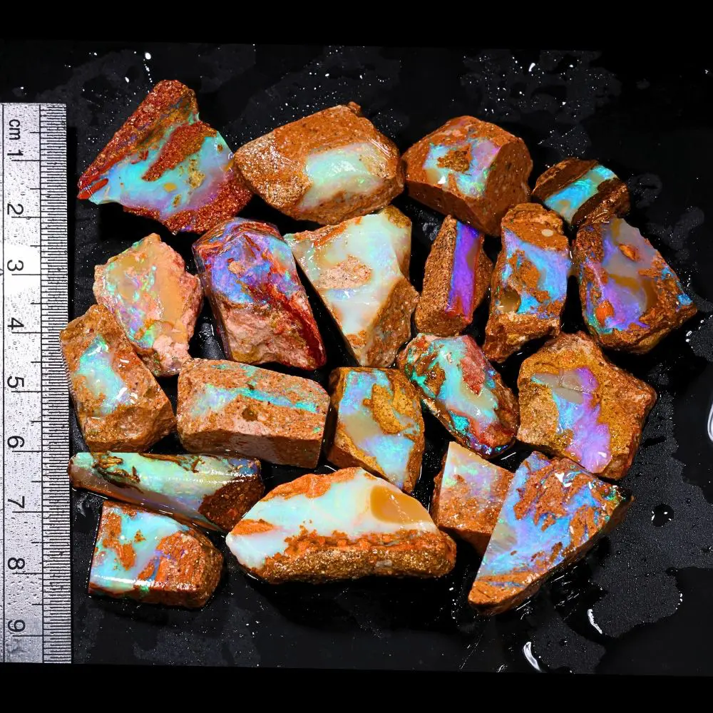 374ct crystal boulder opal rubs parcel from Winton, Australia showing translucent pastel opal with blue, green, and purple fire across broad polished faces. 100% natural and untreated.