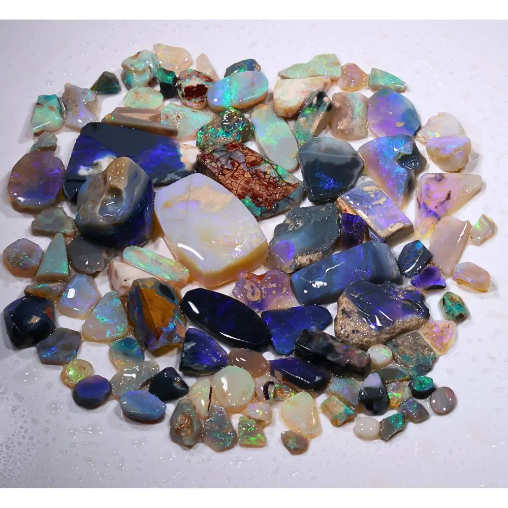 541ct Lightning Ridge opal rubs parcel of 92 pieces from Australia featuring black, crystal, and white opal with blue, purple, and green fire. Natural, untreated.