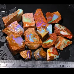 583ct crystal boulder opal rubs parcel from Winton, Australia showing purple, blue, and teal crystal fire across a varied mix of polished faces. 100% natural and untreated.