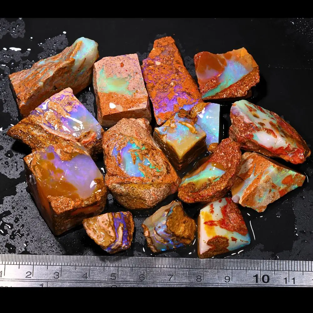 583ct crystal boulder opal rubs parcel from Winton, Australia showing purple, blue, and teal crystal fire across a varied mix of polished faces. 100% natural and untreated.