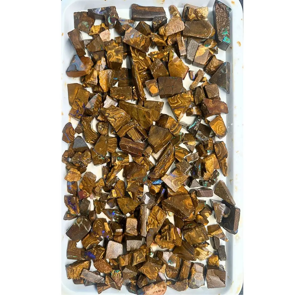 650g boulder opal chips rough parcel from Winton, Australia with blue, green, and purple fire through golden brown ironstone. Natural, untreated inlay material.