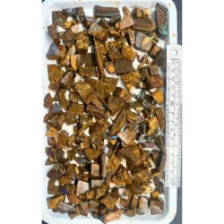 650g boulder opal chips parcel from Winton, Australia showing a large tray of golden brown ironstone pieces with scattered color. 100% natural and untreated.