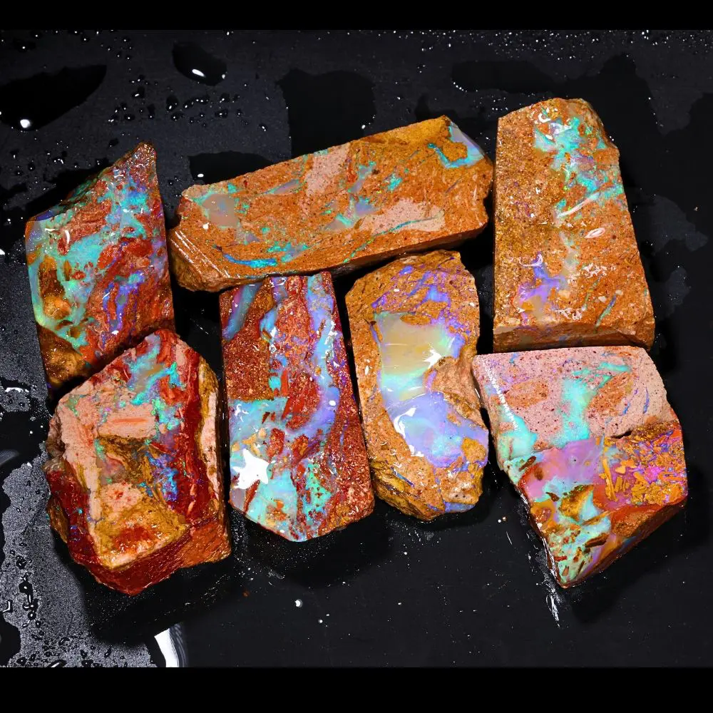 861ct crystal boulder opal rubs rough parcel of 8 pieces from Winton, Australia with blue, purple, teal, and pink crystal opal in natural sandy host rock. Natural, untreated.