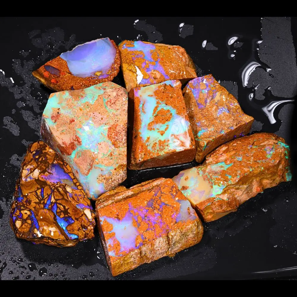 888ct crystal boulder opal rubs rough parcel of 8 pieces from Winton, Australia with blue, purple, and lavender crystal opal in natural sandy host rock. Natural, untreated.