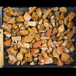 1.8kg Crystal Boulder Opal rough parcel from Winton Australia showing mixed ironstone pieces with visible opal color beside a ruler