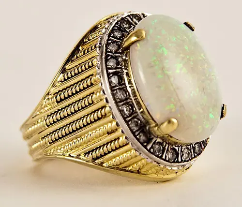 Vintage fourteen karat gold and diamond ring featuring a natural Australian opal cabochon