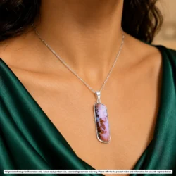 Pink Winton boulder opal pendant shown worn on a silver chain with green and orange color visible