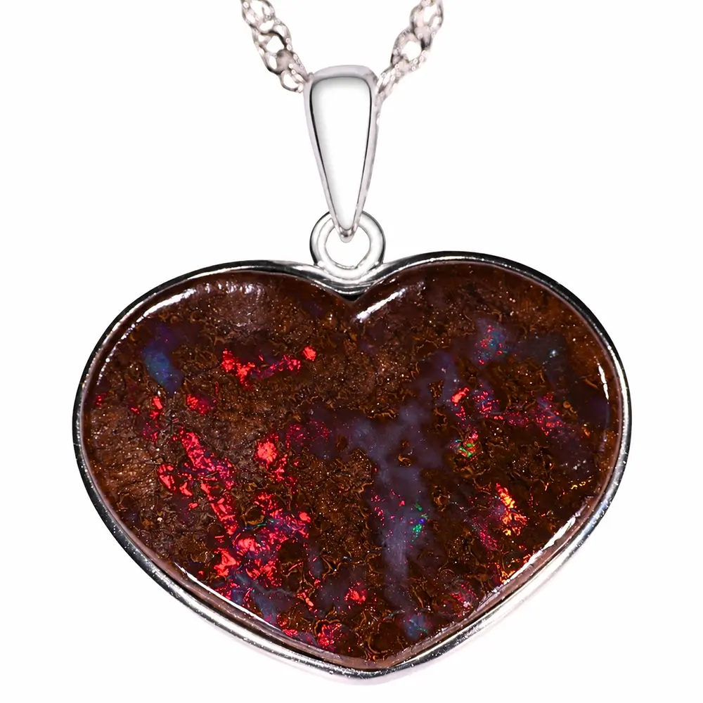 Close view of 31.7 ct Australian boulder opal heart pendant showing bright red fire in natural brown ironstone matrix
